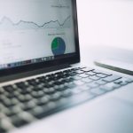 A laptop showing an analytics dashboard with charts and graphs, symbolizing modern data analysis tools.